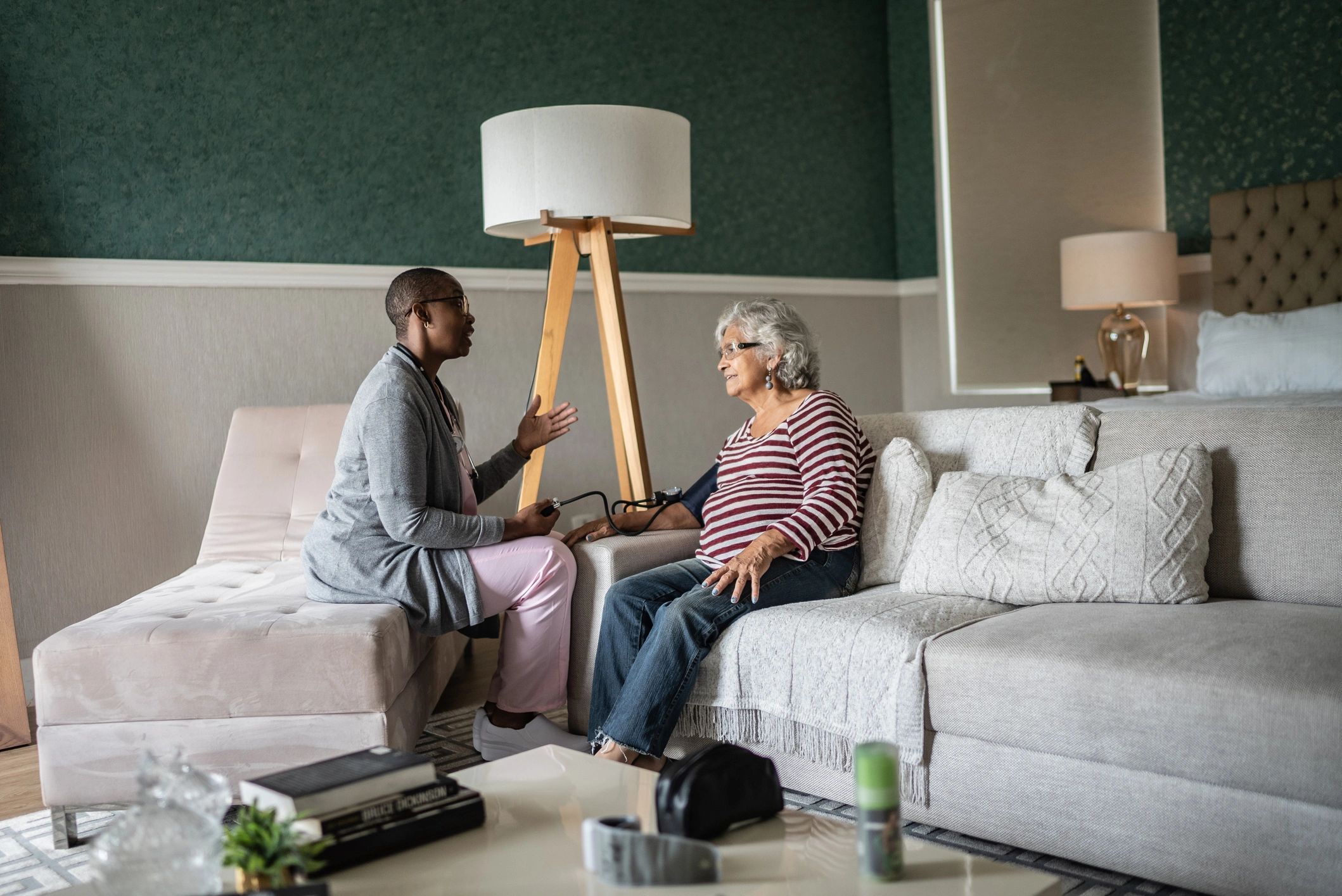 Care professional speaking with clients during an in-home visit