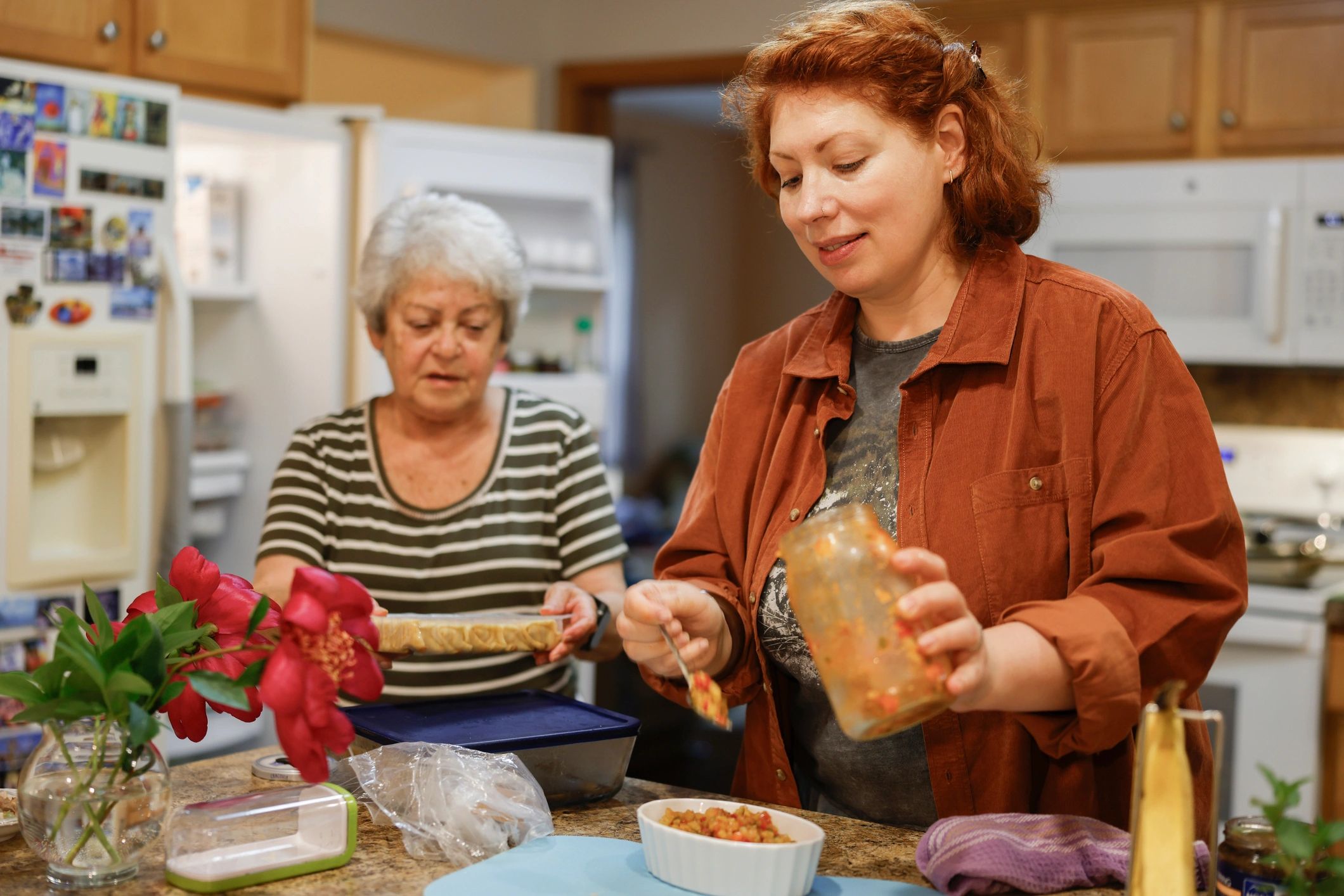 Caregiver sitting warmly with an elderly woman at home in Houston