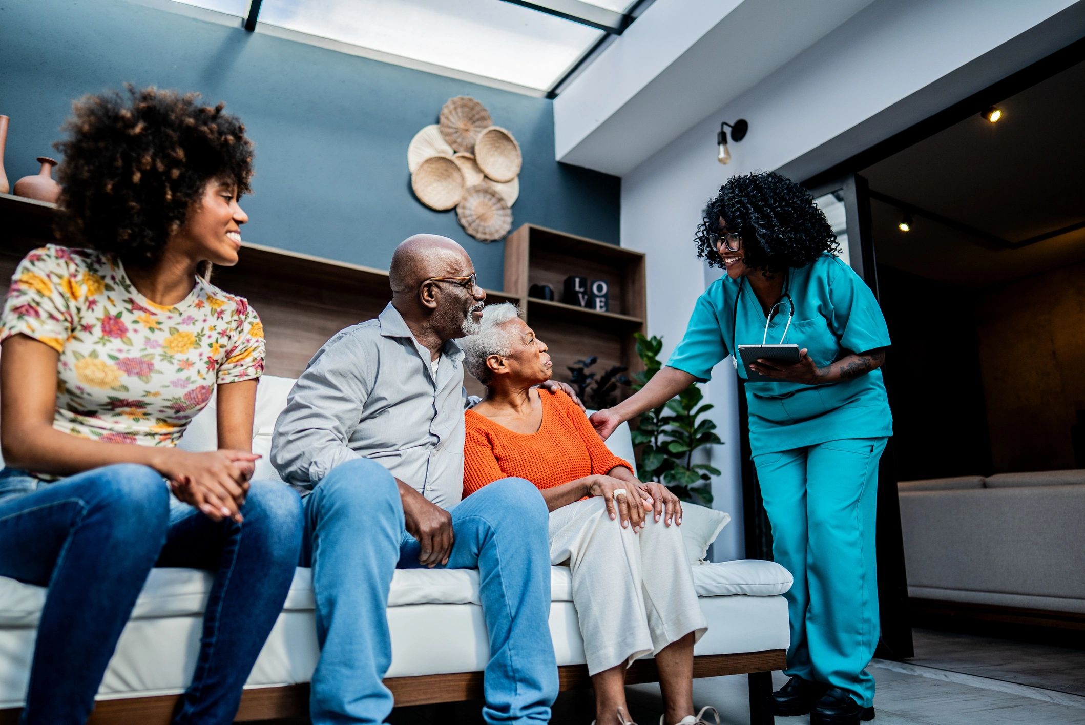 Senior couple with caregiver at home in Houston