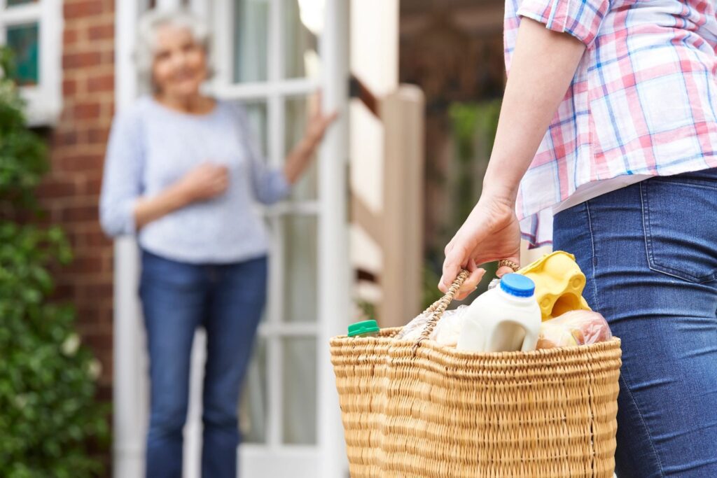 Caregiver helping senior woman with grocery shopping in Sugar Land Fort Bend County
