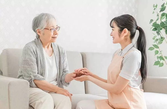 Professional caregiver assisting senior woman at her Woodlands home