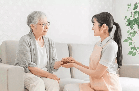Professional caregiver assisting senior woman at her Woodlands home