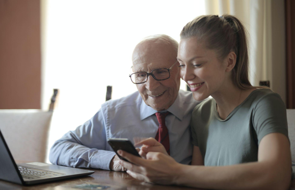 Nurse reviewing documents with an elderly patient at home