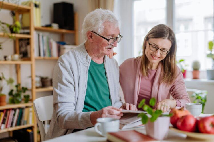 Senior woman enjoying activities with caregiver at home