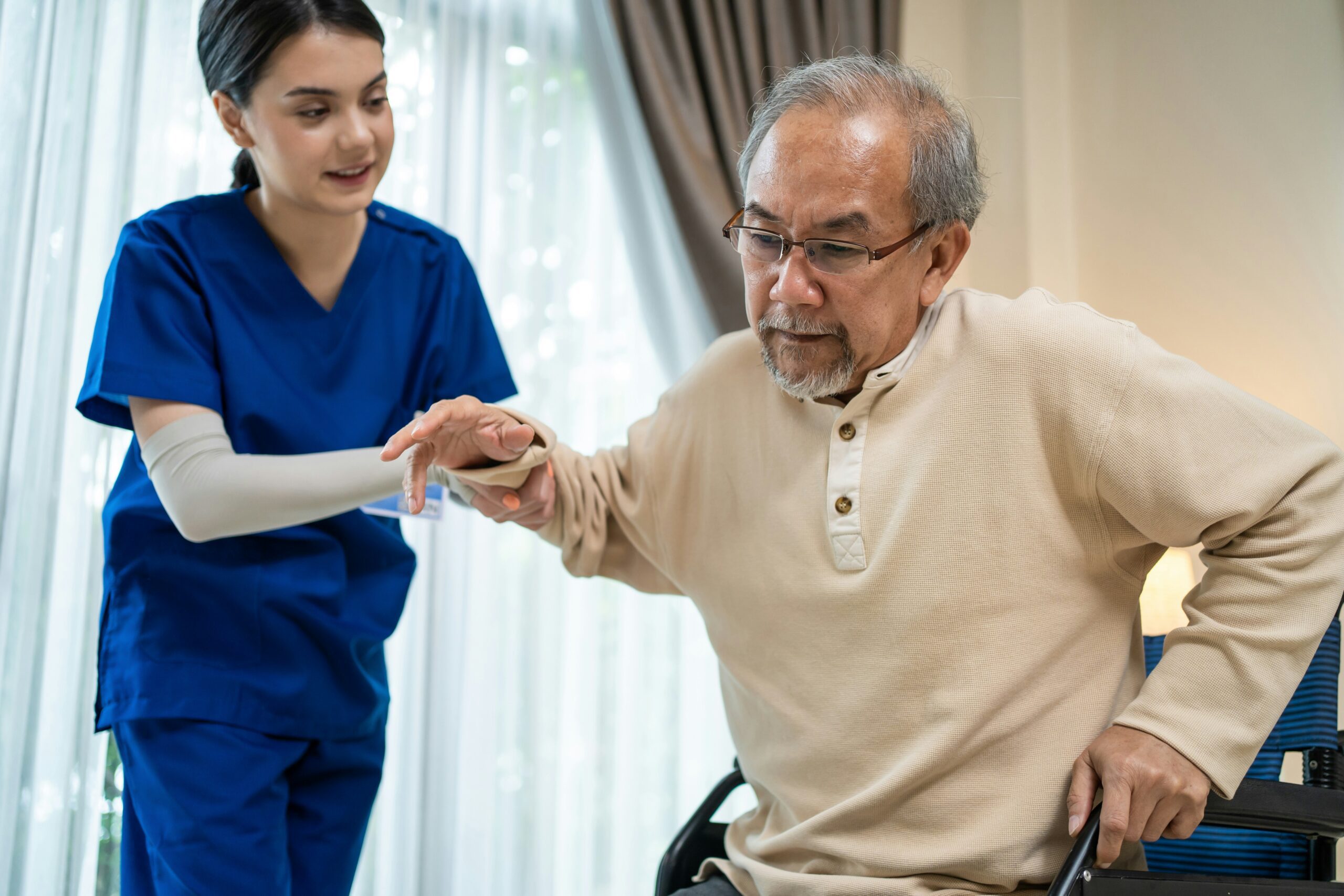 Senior safely walking at home with caregiver support — fall prevention Houston TX
