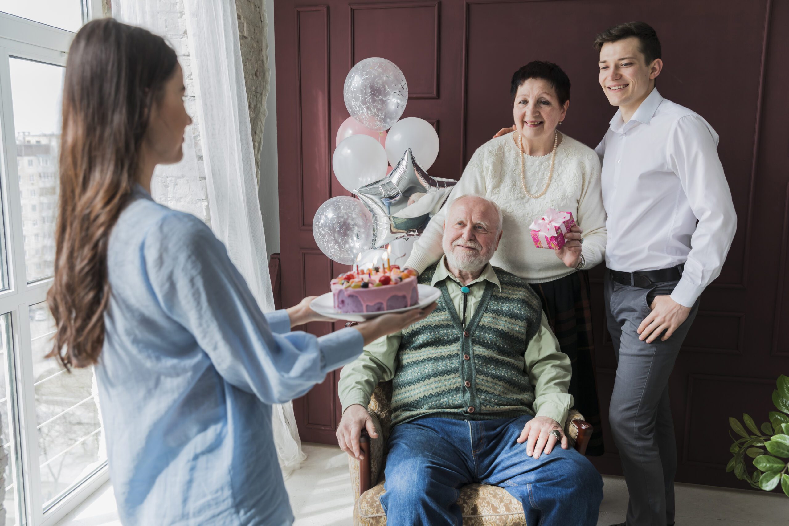 A professional caregiver warmly assisting an elderly woman in her living room in Houston